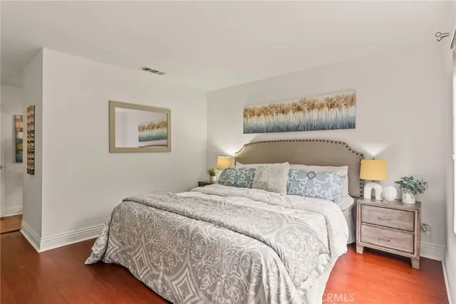 a bedroom with a bed and a night stand