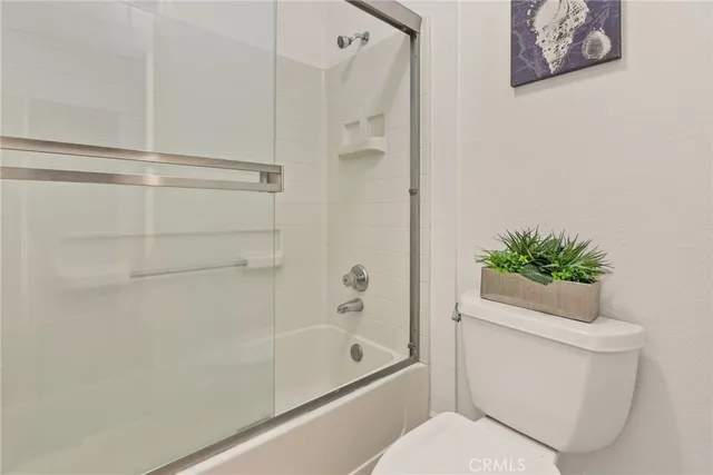 a bathroom with a shower a toilet and a shower