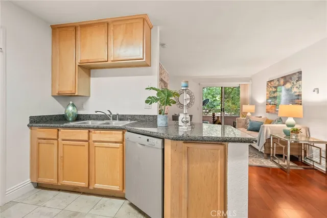 a kitchen with stainless steel appliances granite countertop a sink and a cabinets