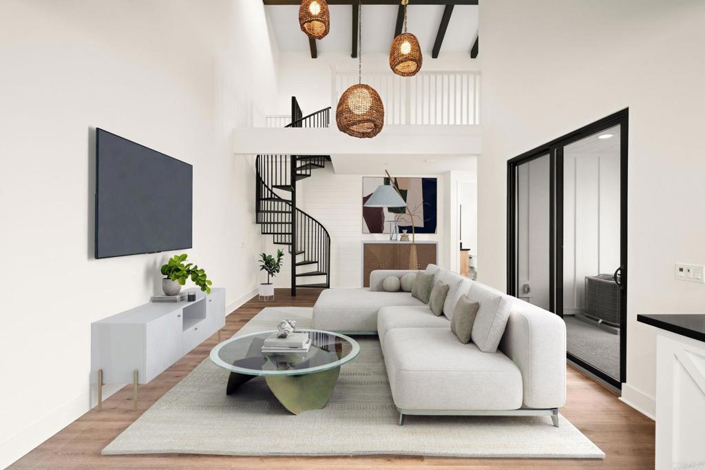 a living room with furniture and wooden floor