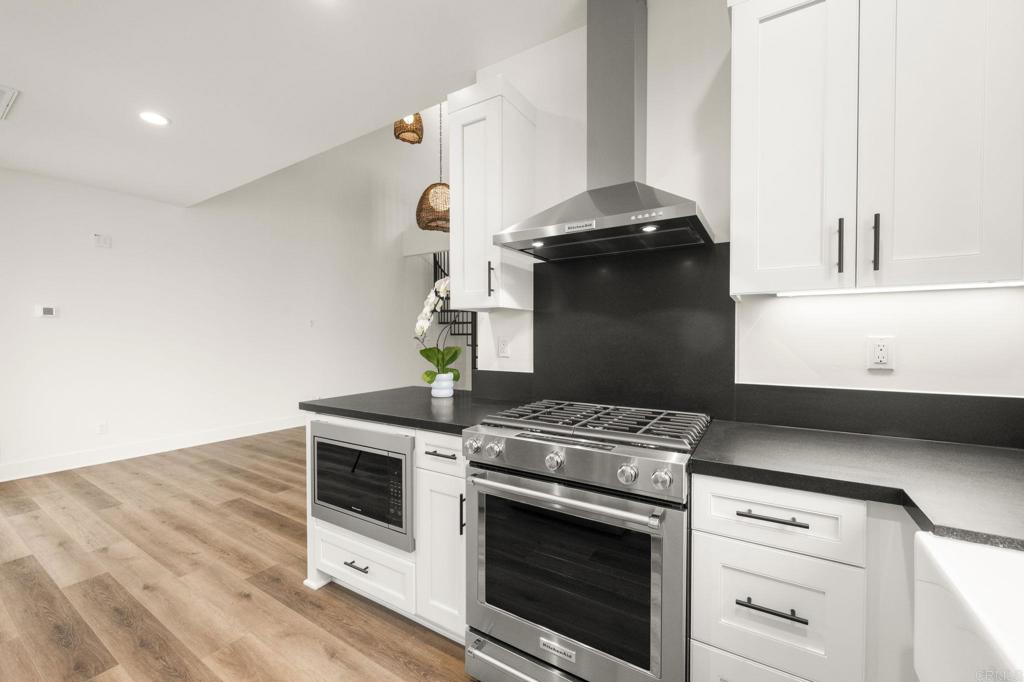 1303 Bergamo Encinitas, CA 92024 - Photo 3 of 21 a stove top oven sitting inside of a kitchen