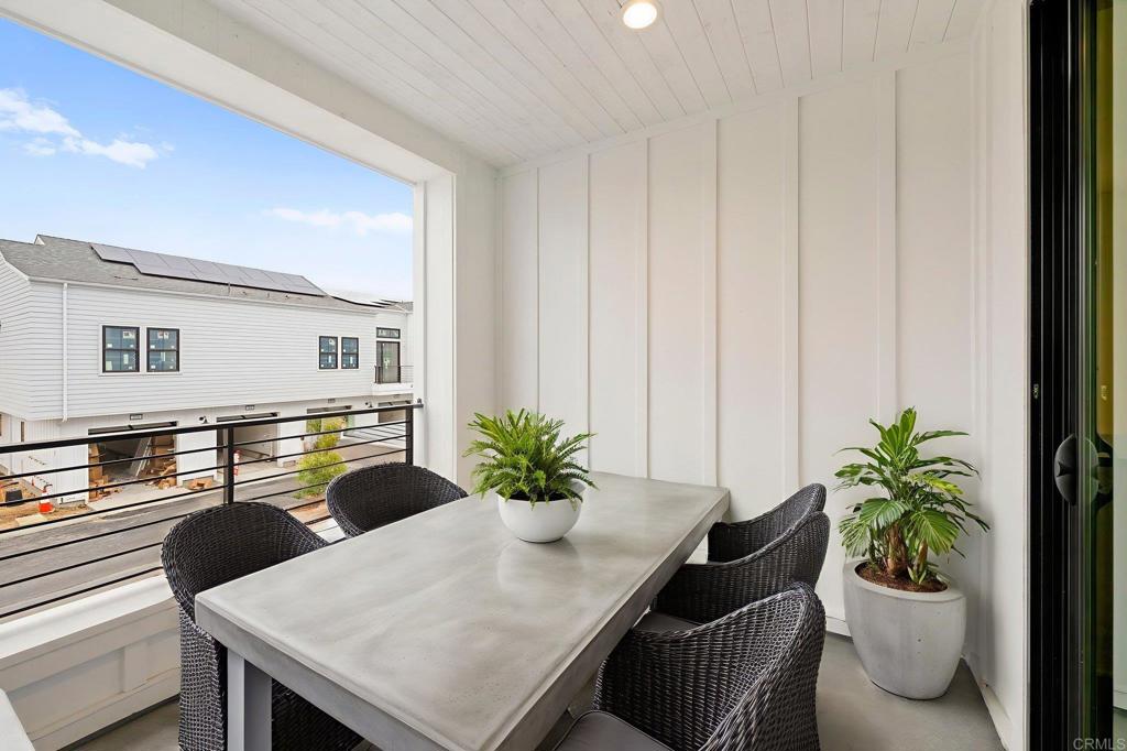 1303 Bergamo Encinitas, CA 92024 - Photo 7 of 21 a dining room with furniture and a potted plant