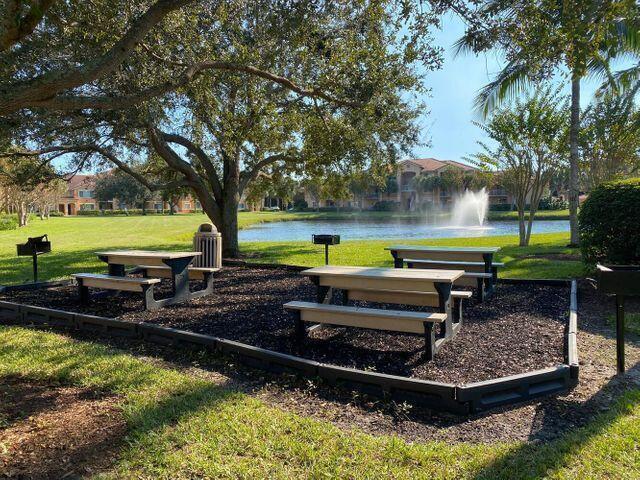 251 Southwest Palm Drive, Unit 204 Port St. Lucie, FL 34986 - Photo 7 of 14 a swimming pool covered with green trees