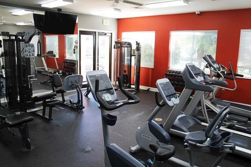 251 Southwest Palm Drive, Unit 204 Port St. Lucie, FL 34986 - Photo 8 of 14 a room with gym equipment and a large window