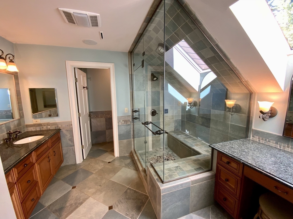 5 Pocumtuck Drive Deerfield, MA 01373 - Photo 28 of 42 a spacious bathroom with a granite countertop sink and a mirror