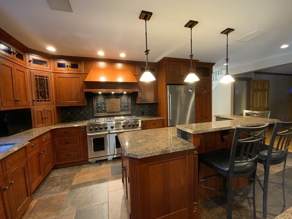 5 Pocumtuck Drive Deerfield, MA 01373 - Photo 5 of 42 a kitchen with stainless steel appliances granite countertop a sink a stove and a wooden floors