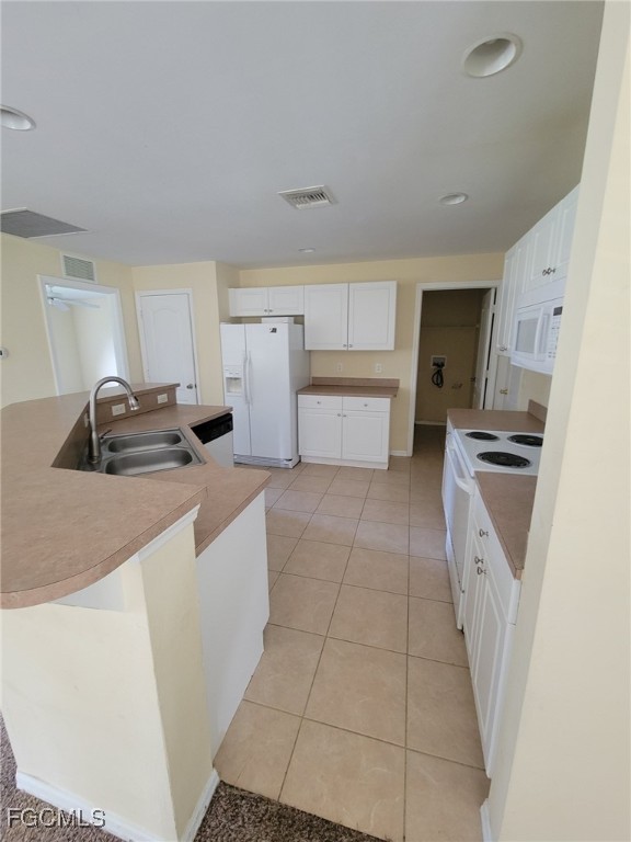 668 Homestead Road South Lehigh Acres, FL 33974 - Photo 4 of 11 a kitchen with a sink a stove top oven and refrigerator