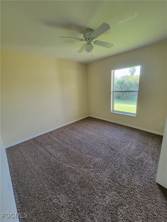 668 Homestead Road South Lehigh Acres, FL 33974 - Photo 9 of 11 an empty room with a window