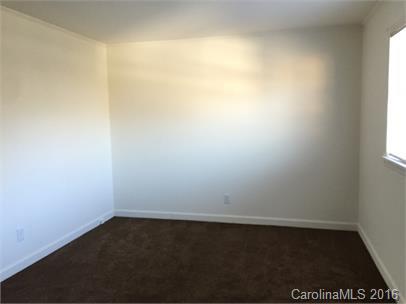 357 Freedom Street Southwest, Unit 2D Concord, NC 28025 - Photo 2 of 5 an empty room with a window