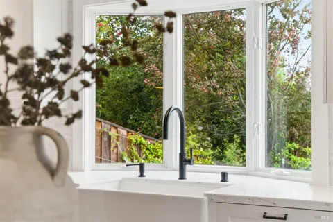 a spacious bathroom with double sink a toilet a shower and a mirror