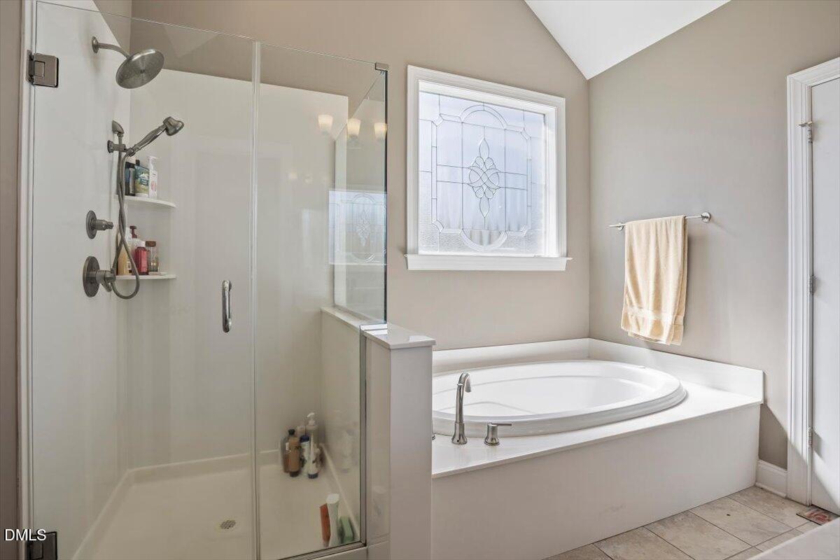 1001 Bellewood Farms Road Raleigh, NC 27603 - Photo 30 of 39 a bathroom with a tub a window and a shower