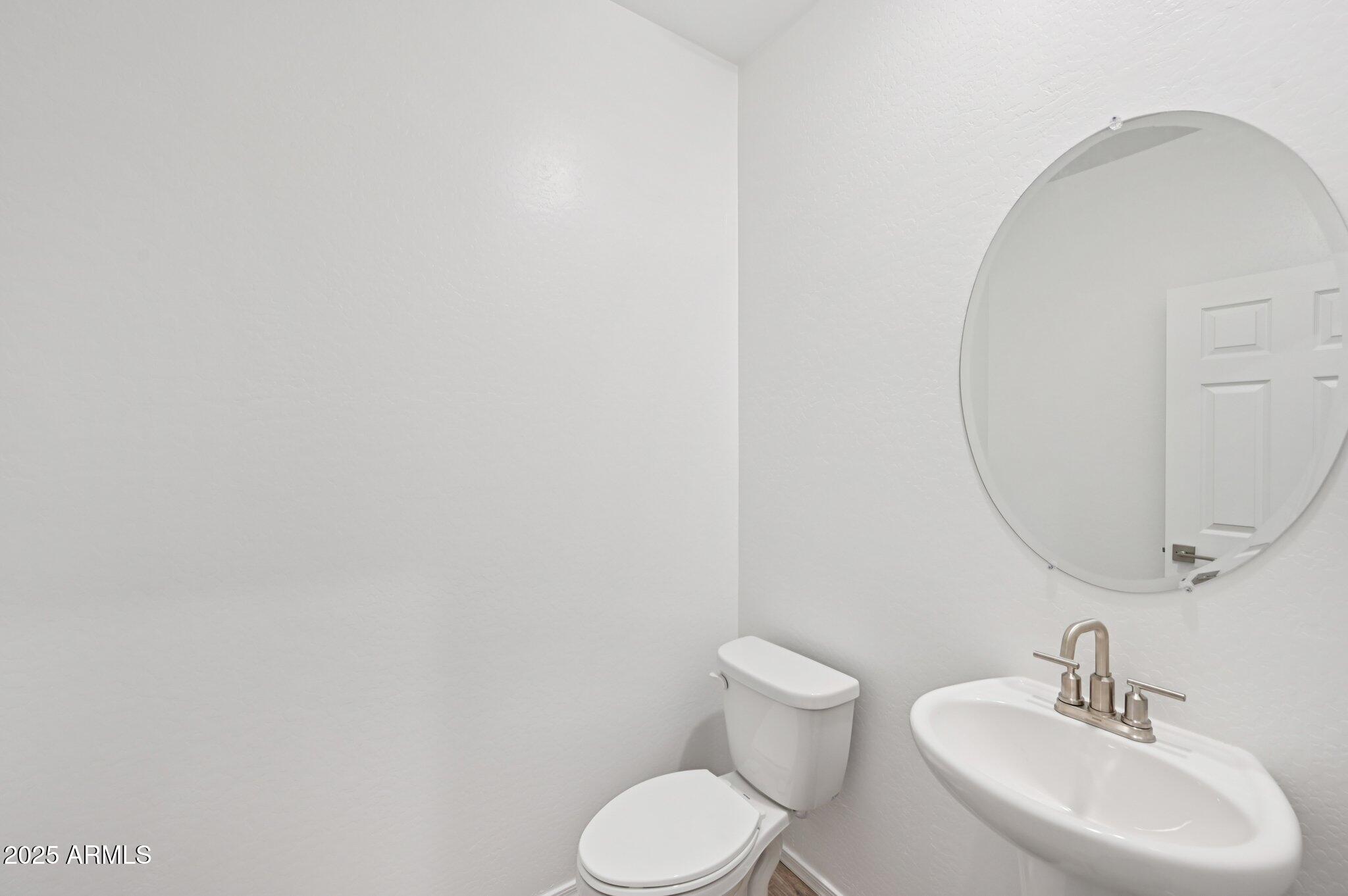 5535 South 240th Lane Buckeye, AZ 85326 - Photo 15 of 57 a bathroom with a toilet sink and mirror