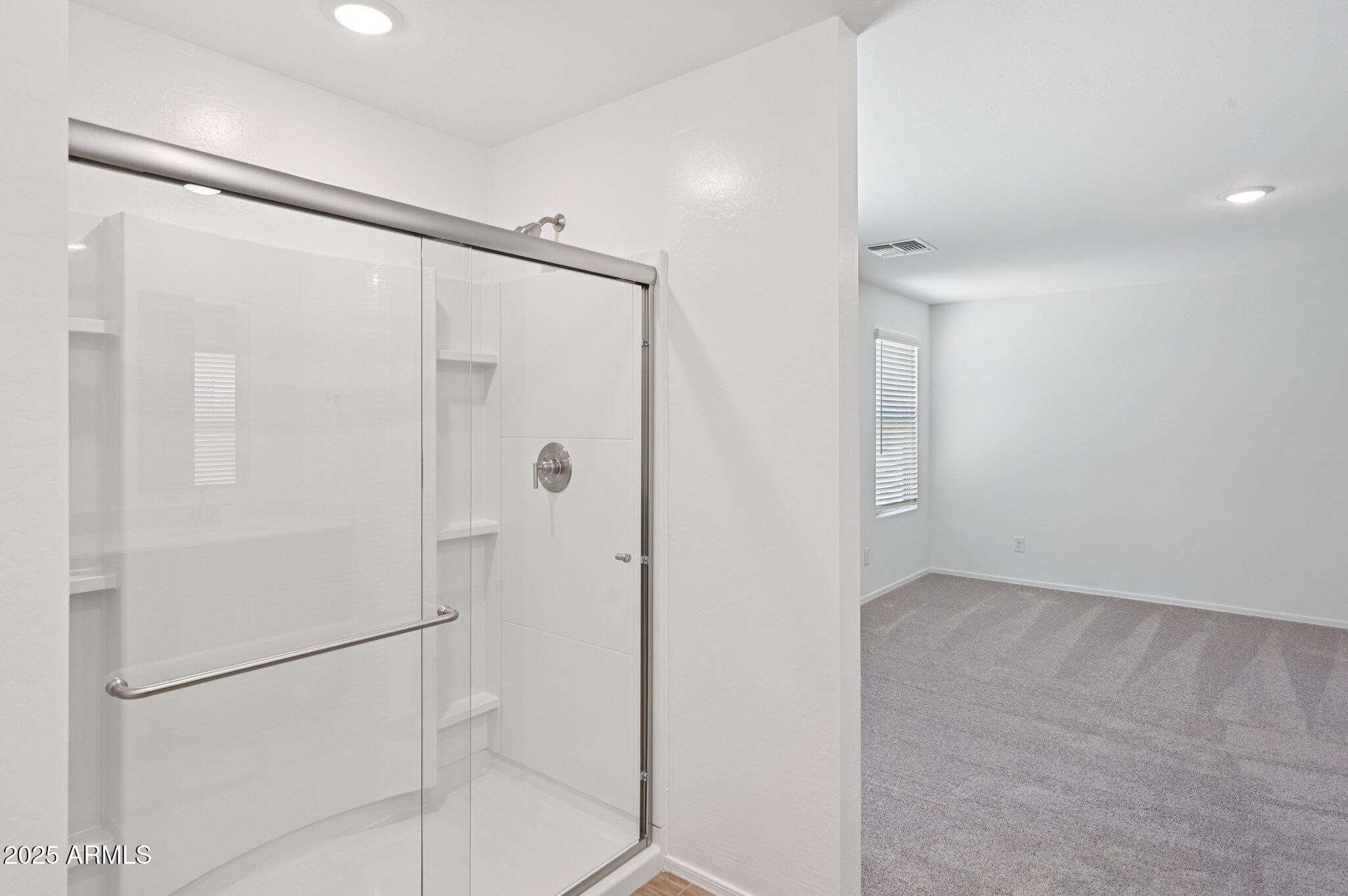 5535 South 240th Lane Buckeye, AZ 85326 - Photo 28 of 57 a bathroom with a shower and a glass door