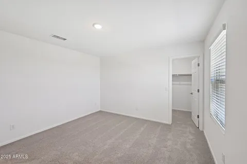 a view of an empty room and a window