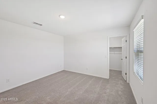 a view of an empty room and a window