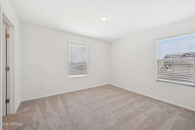 a bedroom with a large bed and a potted plant