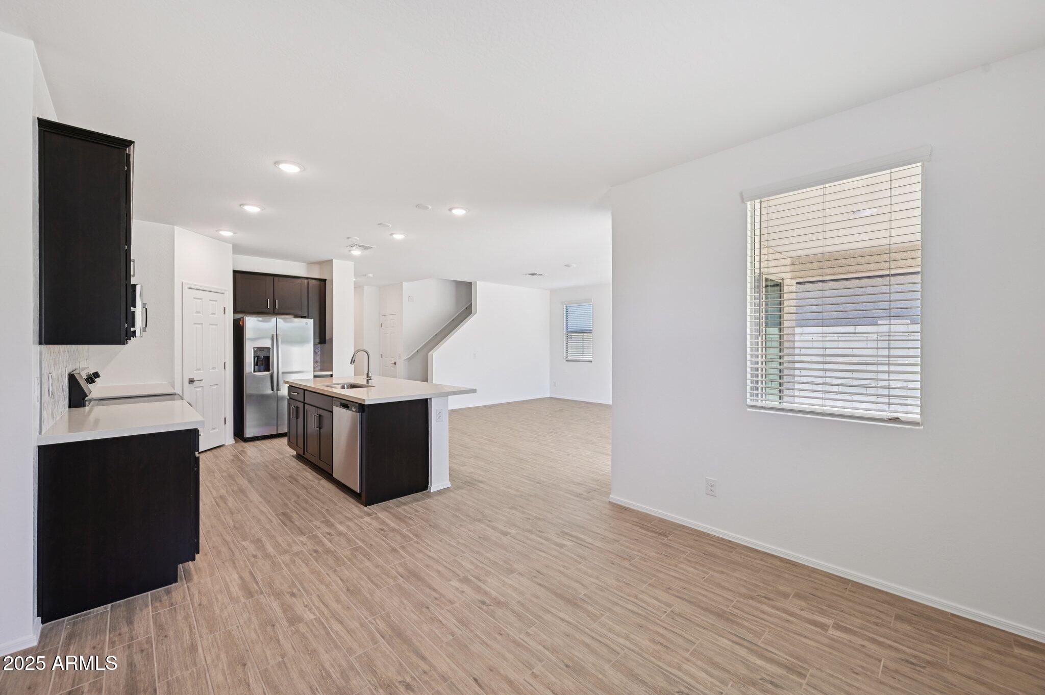 5535 South 240th Lane Buckeye, AZ 85326 - Photo 8 of 57 a living room with furniture and a flat screen tv