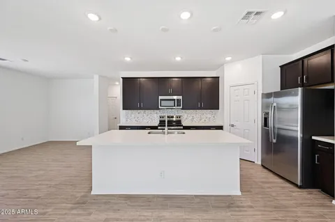 a kitchen with a sink a stove a refrigerator and a refrigerator