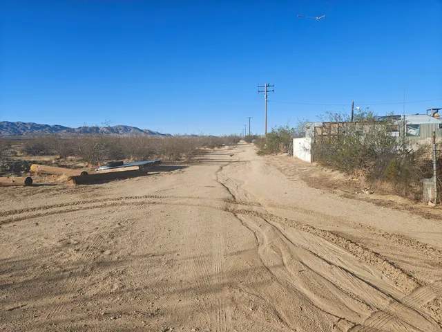 a view of a yard with wooden fence