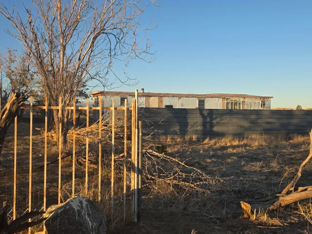 a view of a pathway with a wrought fence