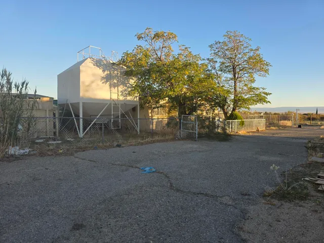 a view of dirt yard with a large tree