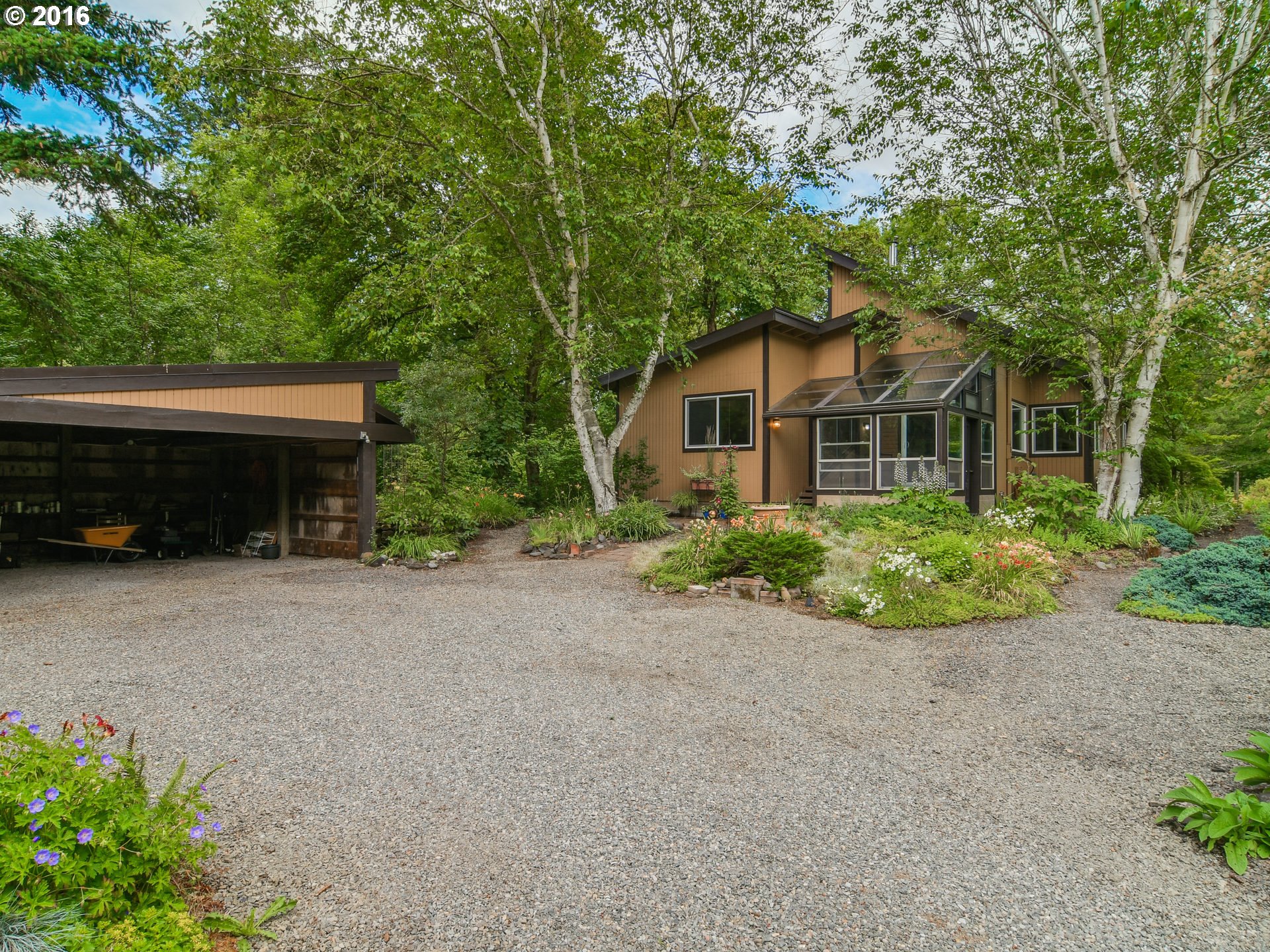 10970 South Mulino Road Canby, OR 97013 - Photo 3 of 32 a front view of a house with a garden
