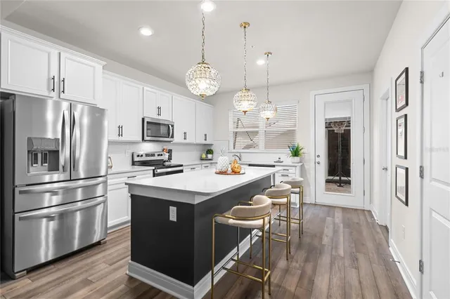 a kitchen with a table chairs a stove a dining table and chairs