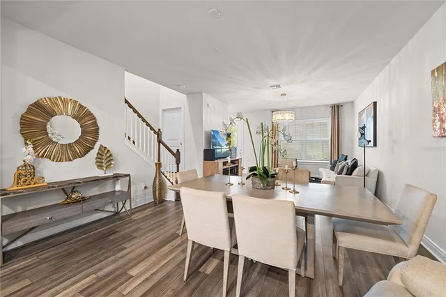 a view of a dining room with furniture and wooden floor