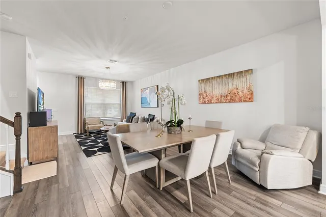 a view of a dining room with furniture and wooden floor