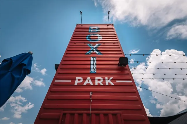 an aerial view of residential houses with outdoor space and ocean view