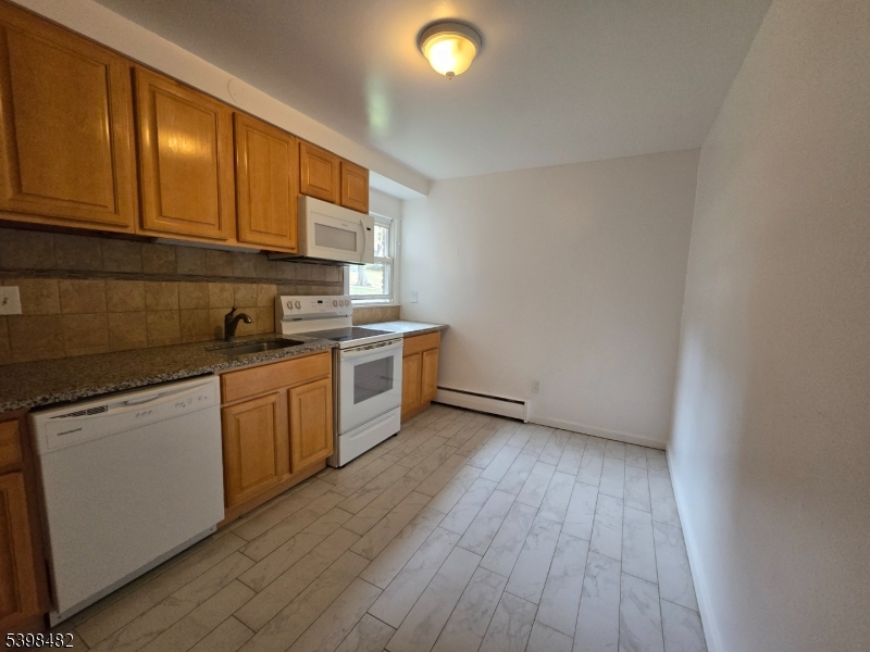 87 Elm Road, Unit 15A Caldwell, NJ 07006 - Photo 2 of 4 a kitchen with sink a microwave and cabinets