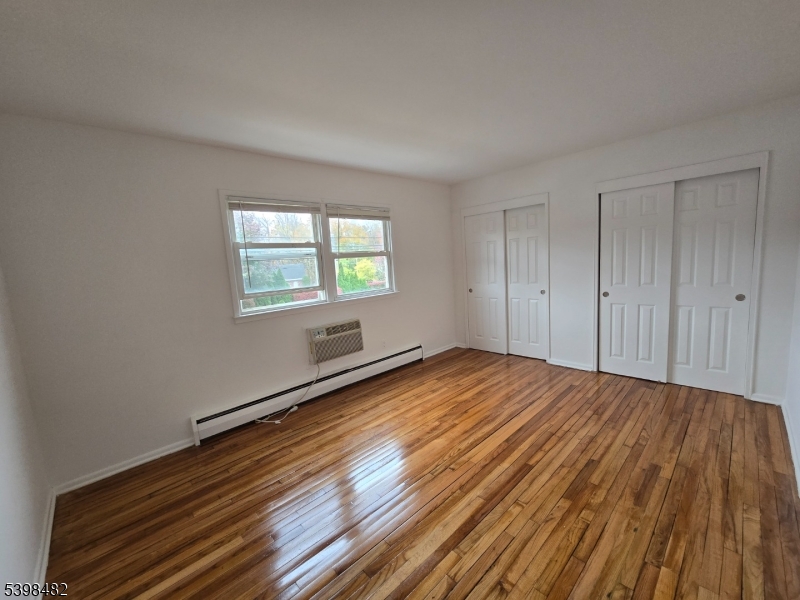 87 Elm Road, Unit 15A Caldwell, NJ 07006 - Photo 4 of 4 a view of empty room with wooden floor and fan