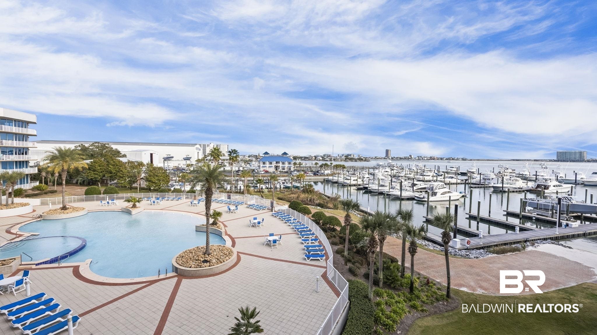 27800 Canal Road, Unit 313 Orange Beach, AL 36561 - Photo 12 of 23 Community pool with view of marina, a water view, and a dock