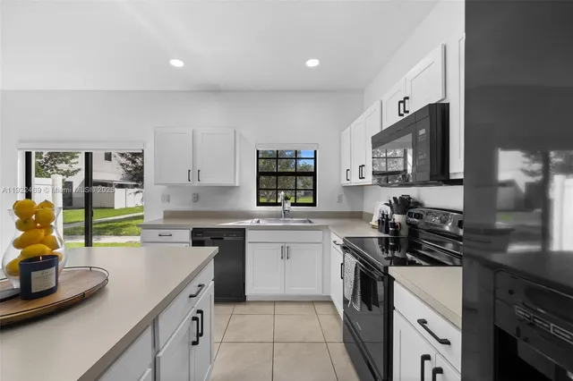 a kitchen with a sink appliances and cabinets