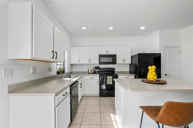 a kitchen with a sink cabinets and appliances