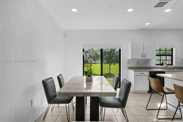 a view of a dining room with furniture a chandelier and wooden floor