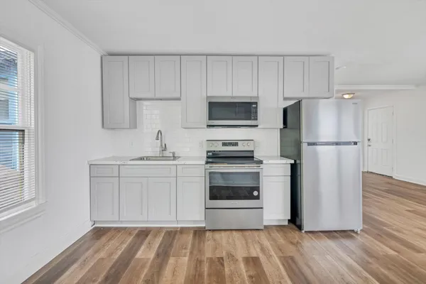 a kitchen with a refrigerator sink and microwave