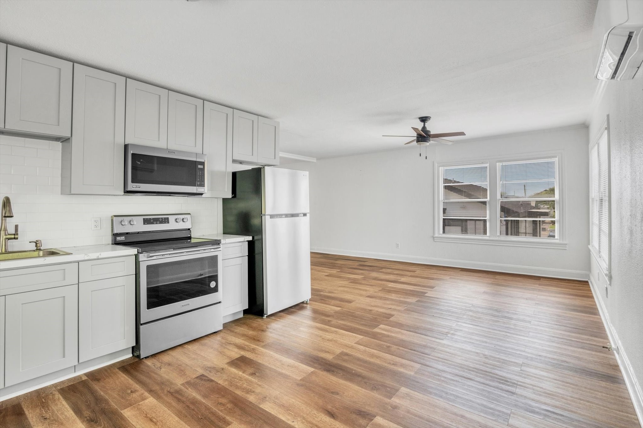 4006 Avenue R 1/2 Rear Galveston, TX 77550 - Photo 11 of 26 a kitchen with granite countertop a refrigerator stove and wooden floor