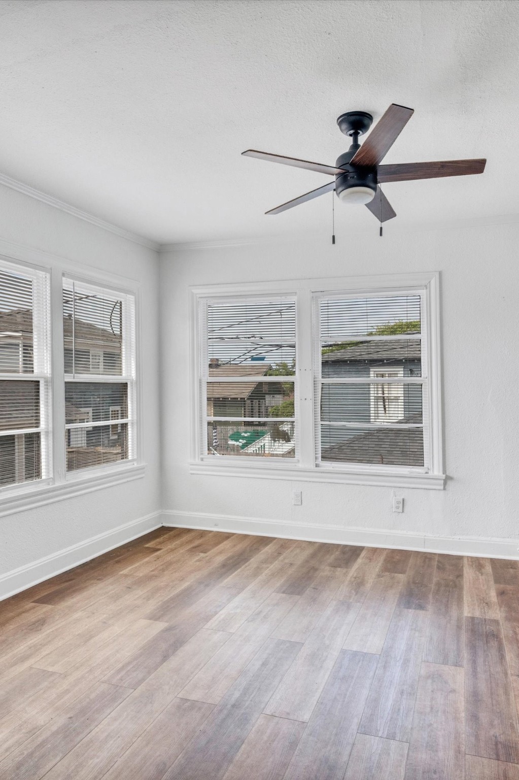 4006 Avenue R 1/2 Rear Galveston, TX 77550 - Photo 13 of 26 a view of an empty room with a window and wooden floor