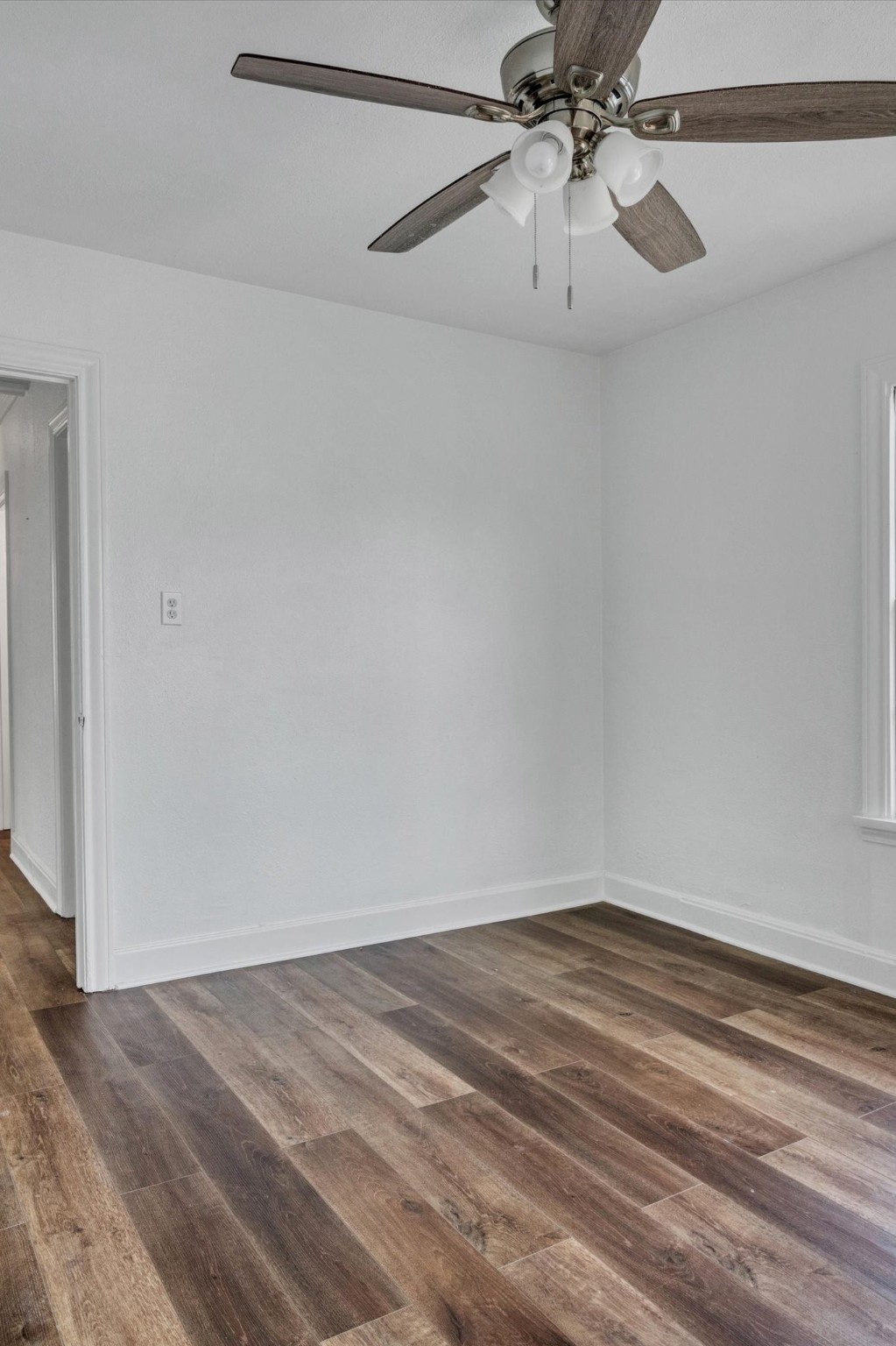 4006 Avenue R 1/2 Rear Galveston, TX 77550 - Photo 20 of 26 a view of a room with wooden floor and a ceiling fan