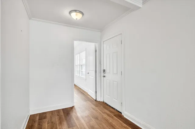 a view of a hallway with wooden floor