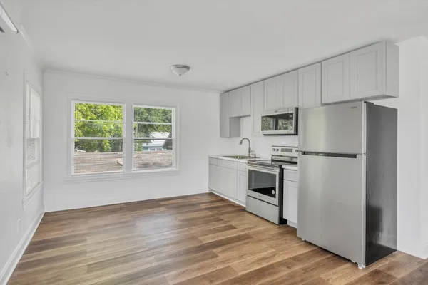 a kitchen with a refrigerator stove and sink
