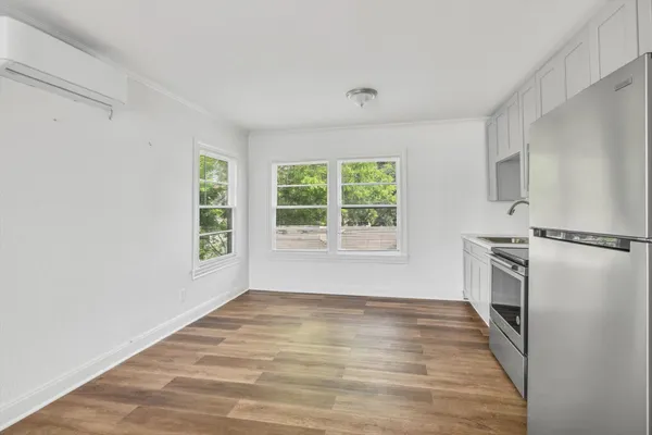 a view of a kitchen with a sink stove refrigerator and window