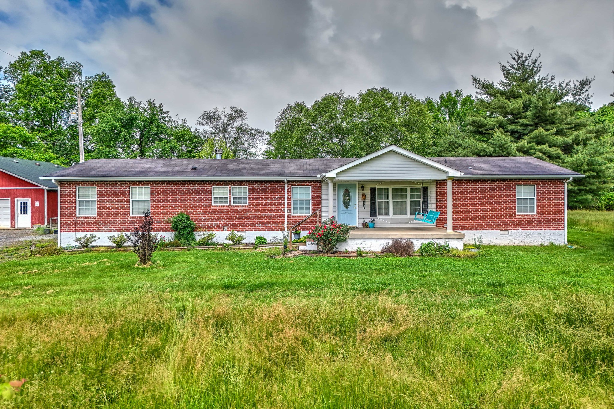 a front view of a house with a garden