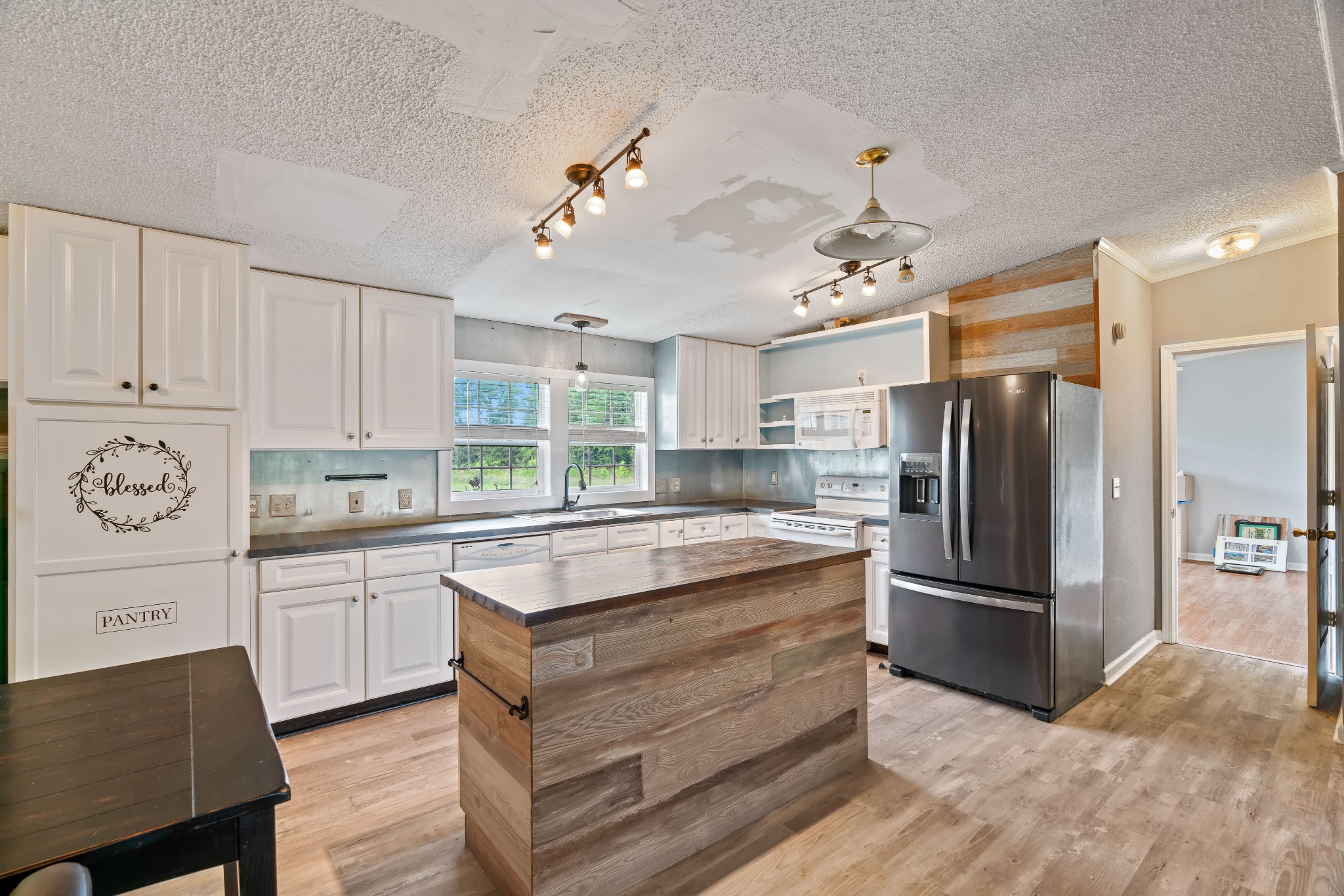 6842 Williams Road Cross Plains, TN 37049 - Photo 21 of 56 a kitchen with kitchen island a refrigerator and a stove top oven
