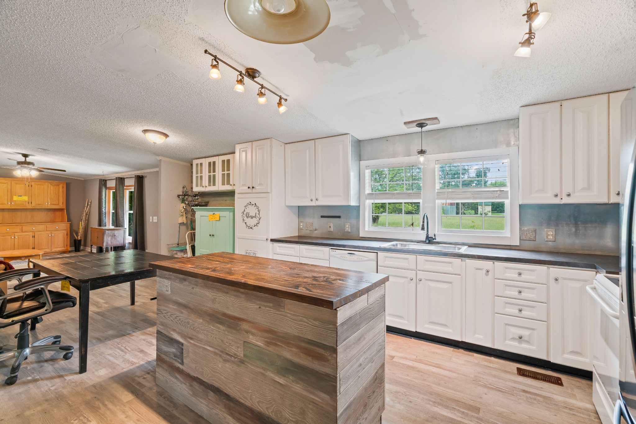 6842 Williams Road Cross Plains, TN 37049 - Photo 22 of 56 a kitchen with a stove a sink a window and chairs