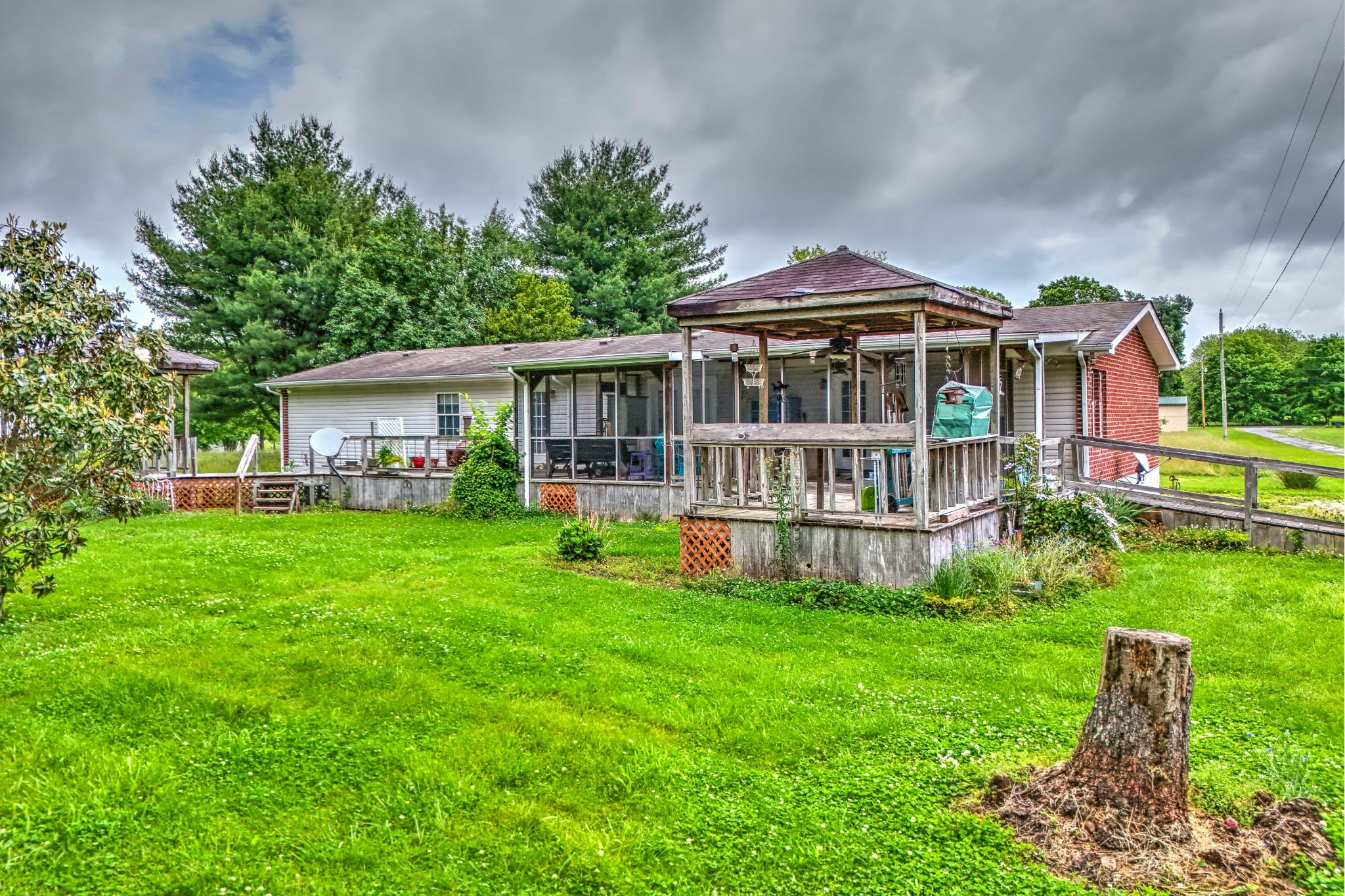 6842 Williams Road Cross Plains, TN 37049 - Photo 4 of 56 a front view of a house with a yard table and chairs