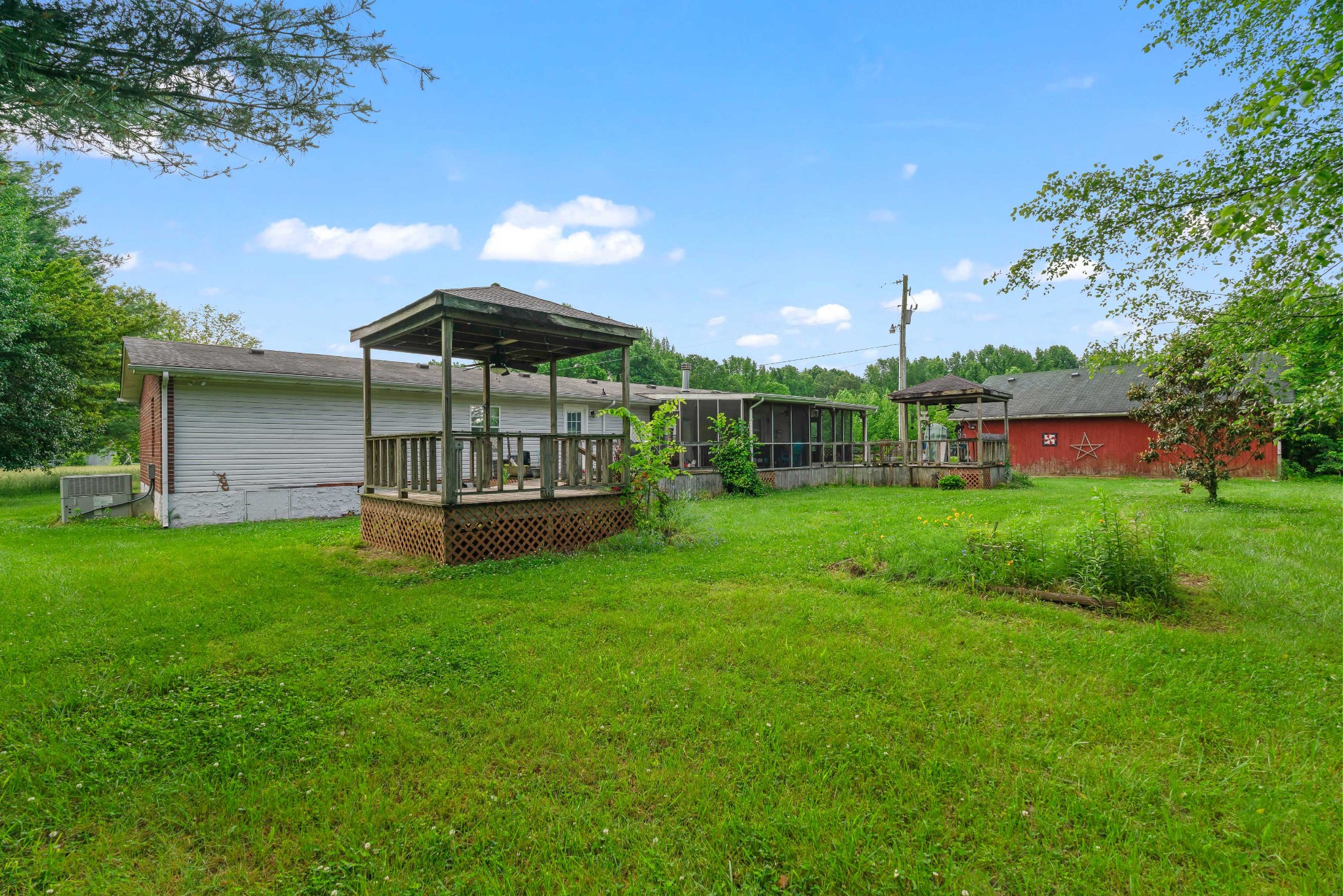 6842 Williams Road Cross Plains, TN 37049 - Photo 54 of 56 a view of a garden with a bench in the garden