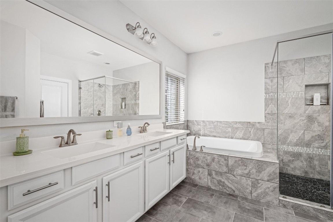 8923 Highgate Lane Houston, TX 77080 - Photo 12 of 23 The bright primary bathroom with double sinks and plenty of thoughtful storage.
