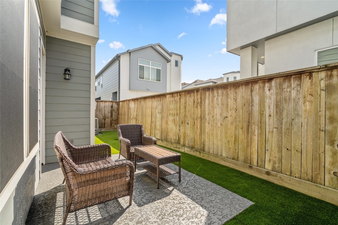 8923 Highgate Lane Houston, TX 77080 - Photo 21 of 23 The backyard features new astroturf and a spacious patio area, perfect for enjoying the cooler months.
